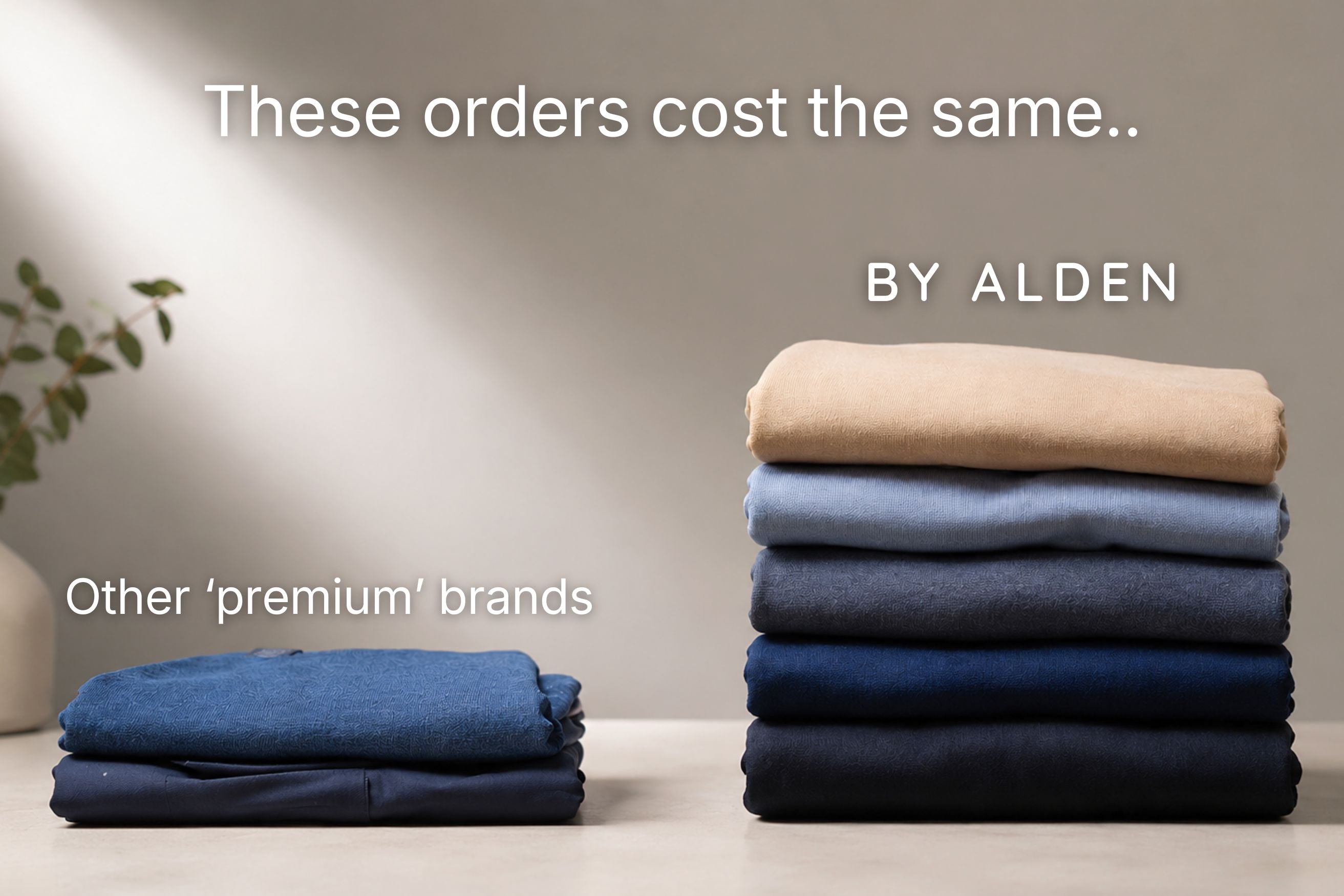 A promotional comparison graphic showing two stacks of folded clothing on a tabletop against a beige wall. The left stack is labeled 'Other premium brands' and contains dark blue folded garments.