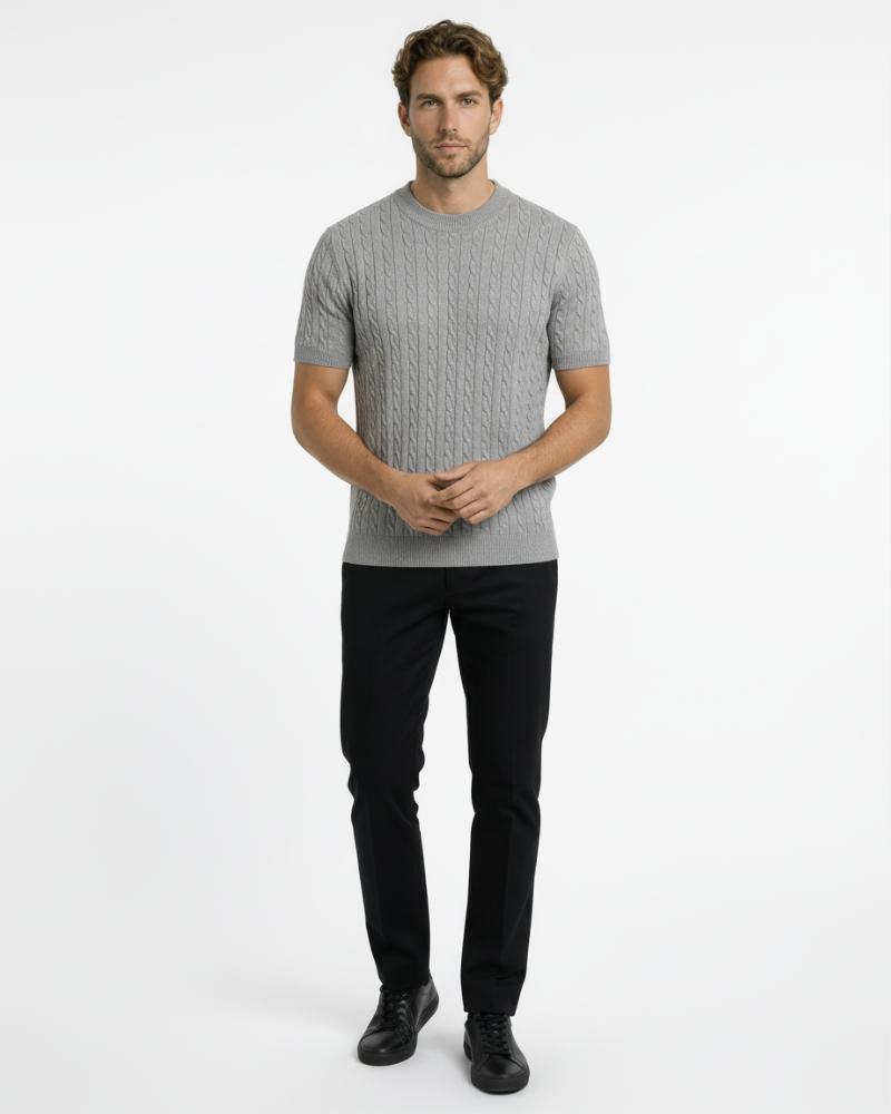 A man in a grey cotton-blend cable knit t-shirt. Minimalist luxury, slim-fit texture, and premium wardrobe staple.