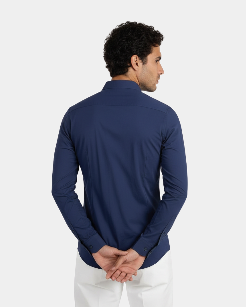 Tailored back view of a luxury navy performance shirt. Minimalist slim fit silhouette in technical stretch fabric.