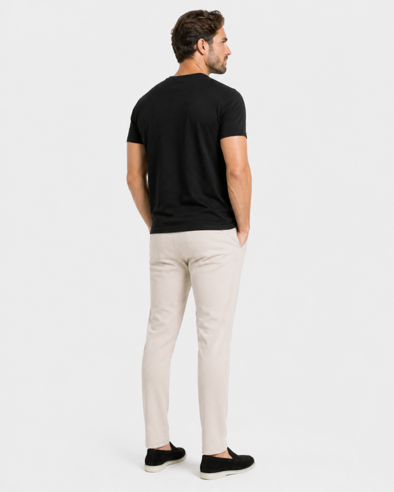 Man wearing a By Alden black t-shirt and beige pants on a white background #Color_beige