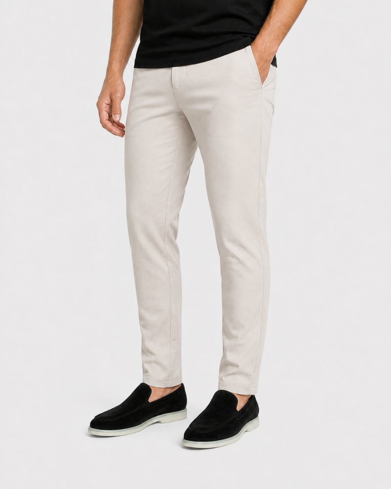 Person wearing By Alden beige pants and black shoes on a white background #Color_beige