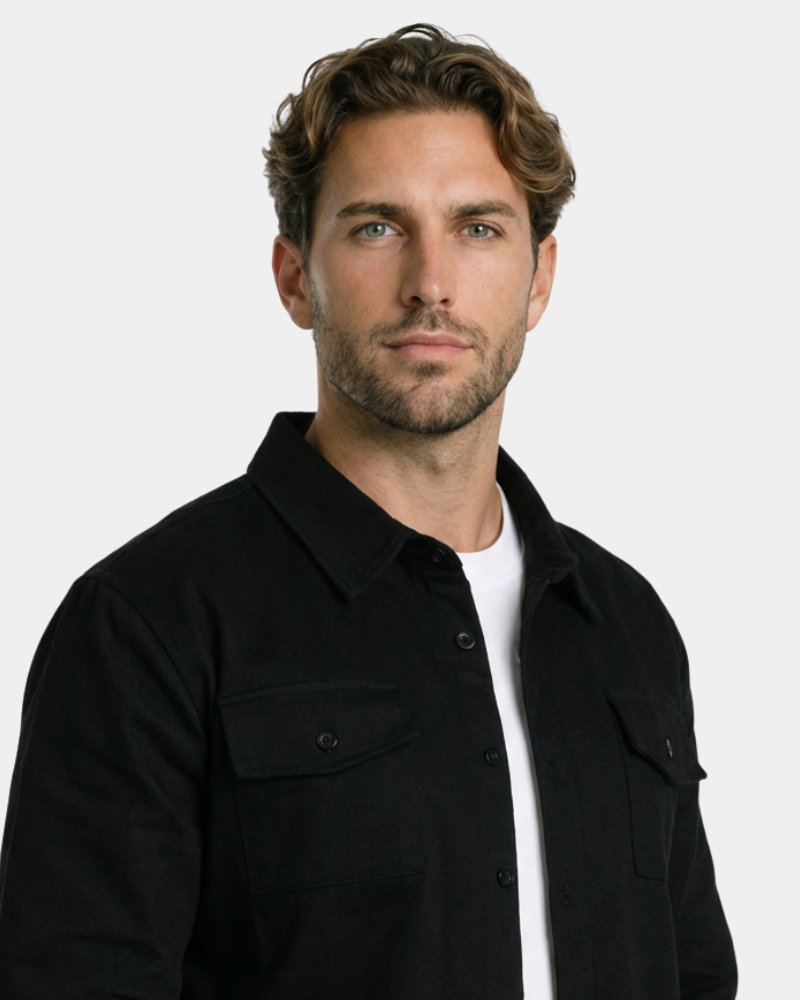By Alden Black Overshirt worn by a White male model, close-up portrait view of collar and chest pocket detail, light grey background #Color_Black