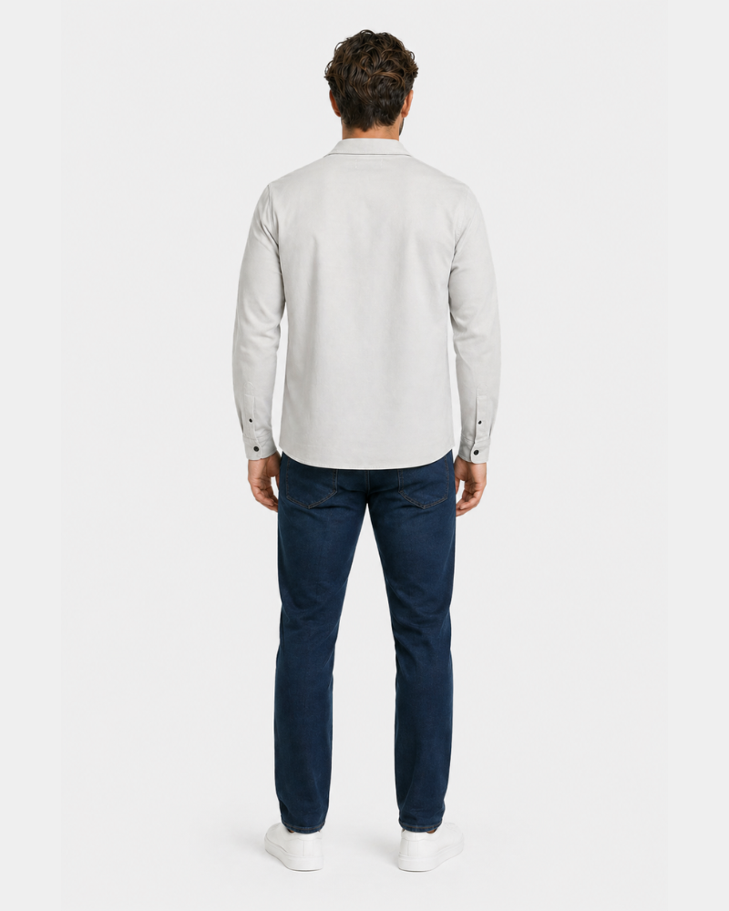 Man wearing a By Alden light gray shirt and dark blue pants on a white background #color_gray