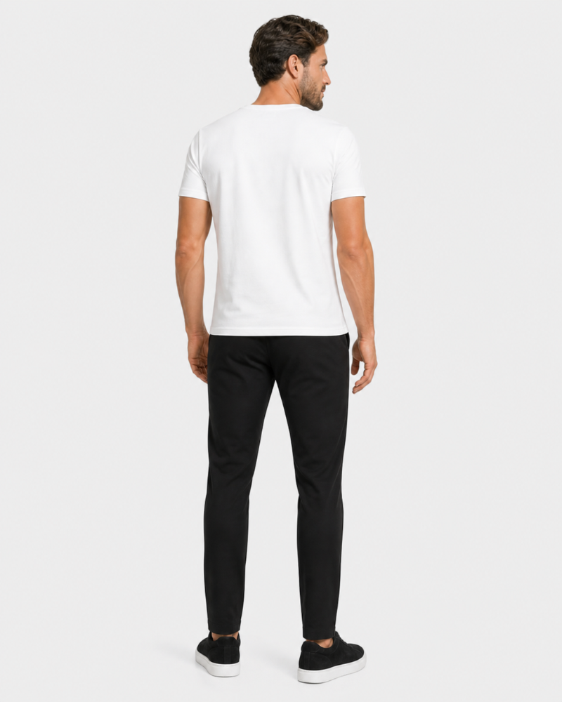 Man wearing a By Alden white t-shirt and black pants on a light gray background #Color_black