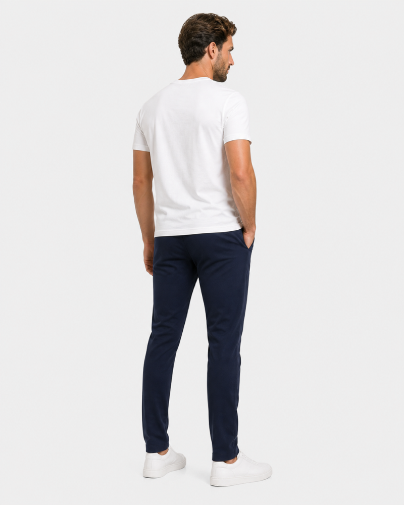 Man wearing a By Alden white t-shirt and navy pants on a white background #Color_navy