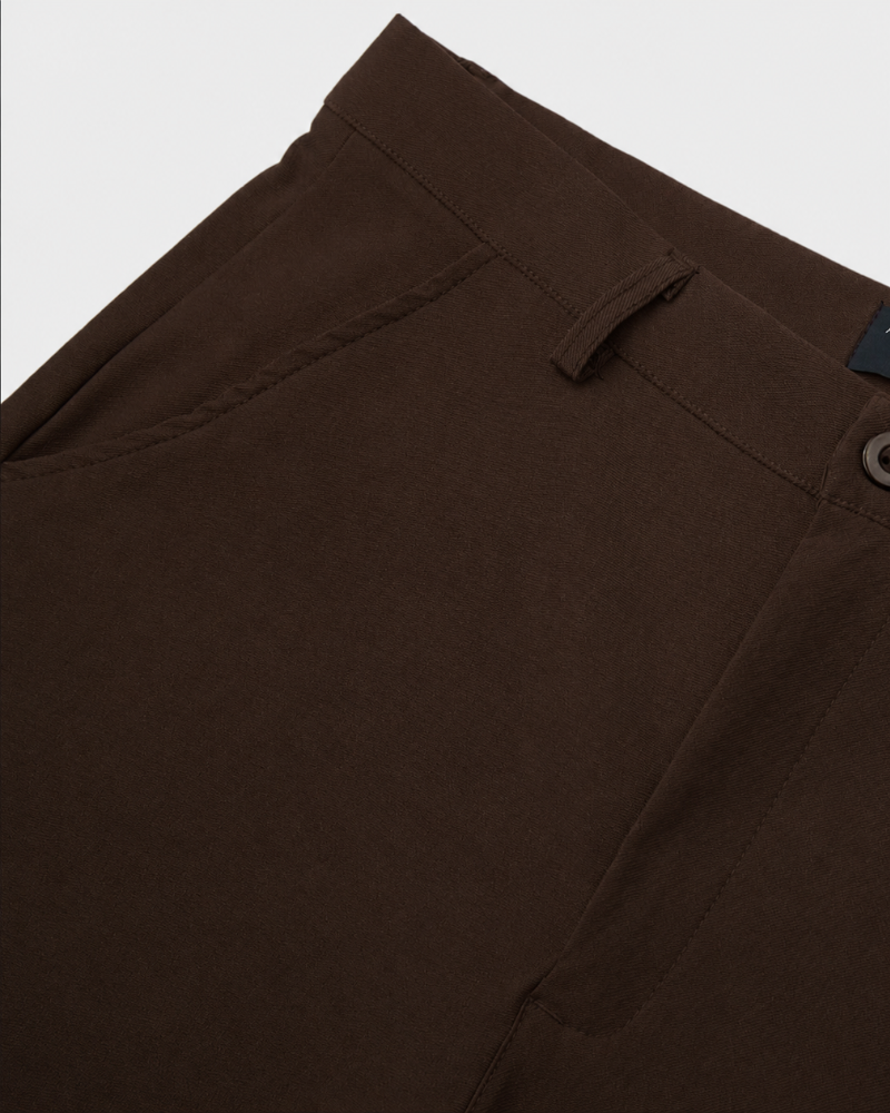 By Alden dark brown chino trousers waistband and pocket detail, flat lay, close-up, light gray background. #color_dark brown