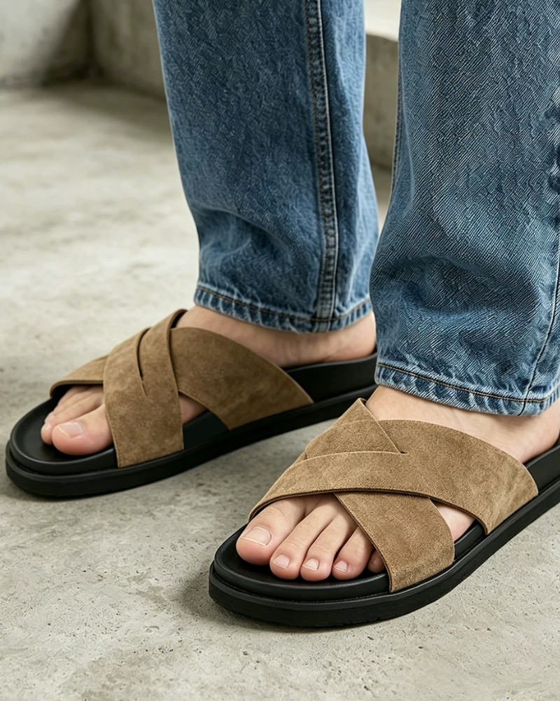By Alden green cross-strap suede slide sandal, male Caucasian model, close-up view, concrete background #Color_camel