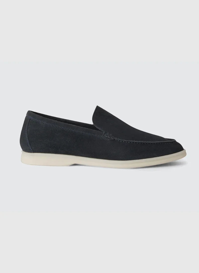 Black suede men's yacht loafer with white sole on light background