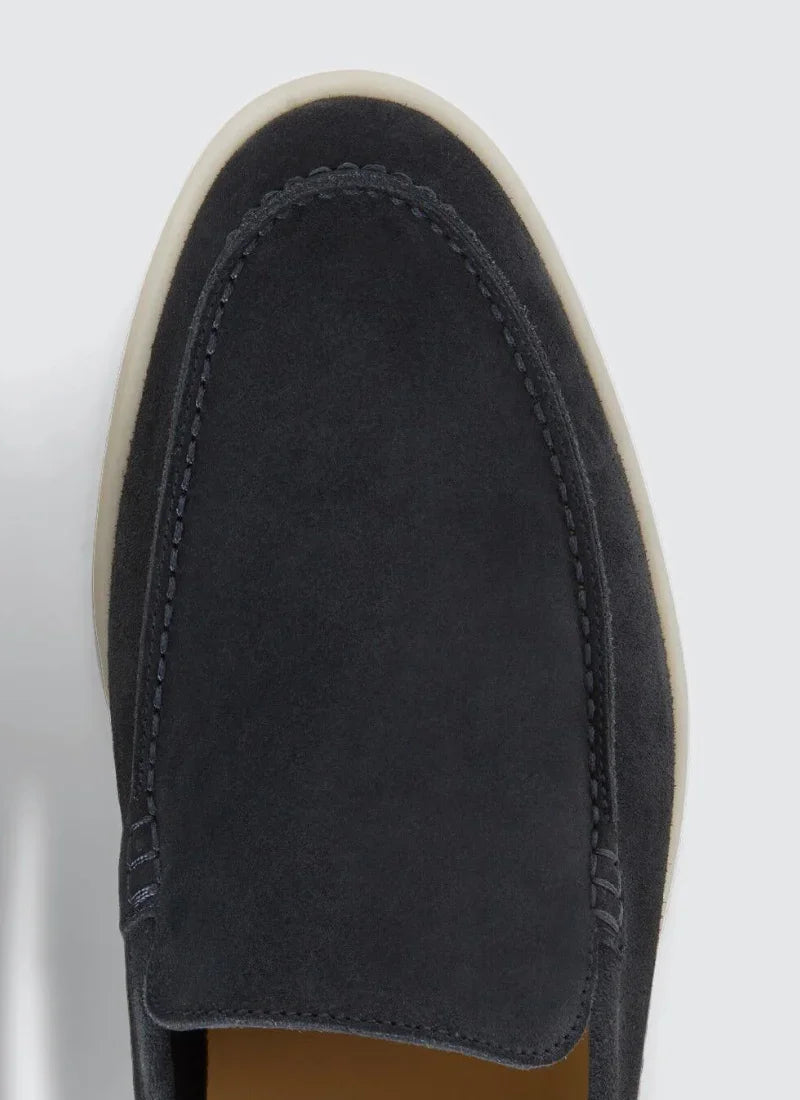 Close-up of black suede Alden Ash Yacht Loafer with white sole on light background