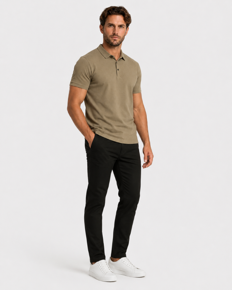Man wearing a beige polo shirt and black pants on a white background #Color_camel
