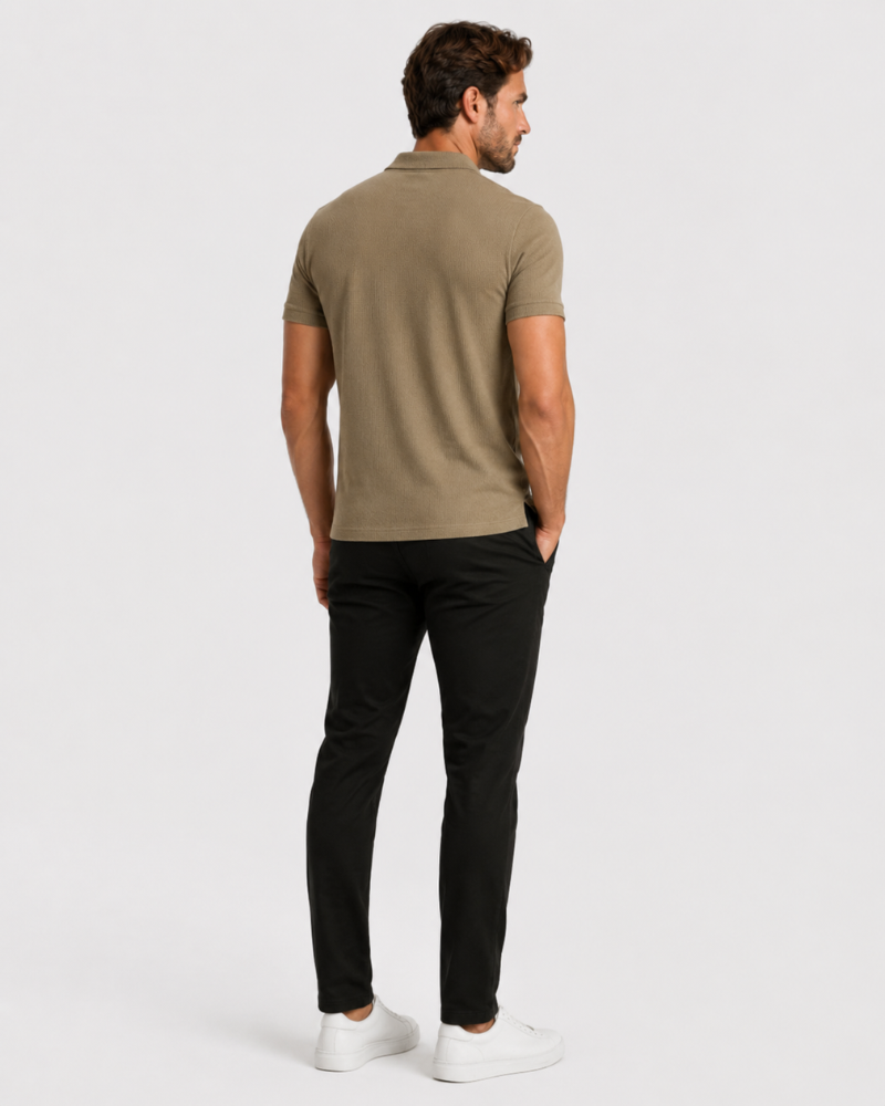 Man wearing a green polo shirt and black pants on a white background #Color_camel