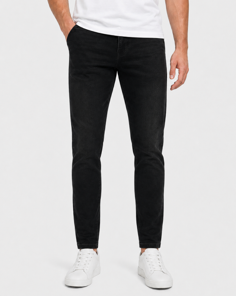 Person wearing black jeans and white sneakers on a white background #Color_black
