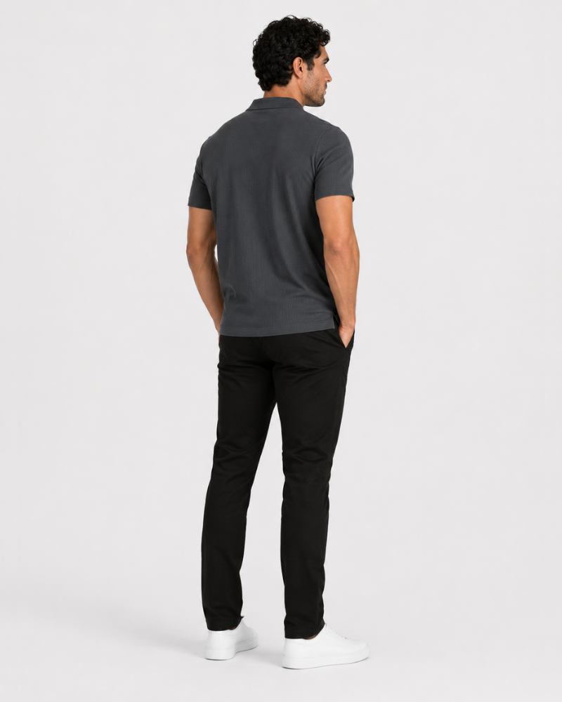 Man wearing a dark gray polo shirt and black pants on a white background #Color_dark gray