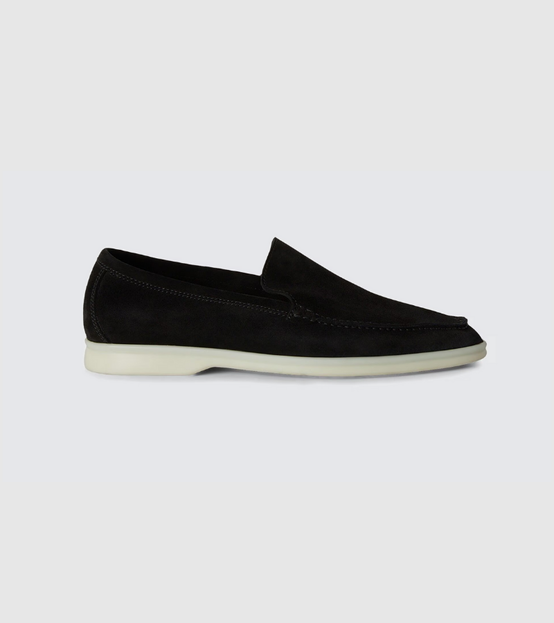 Black loafer shoe on a light gray background