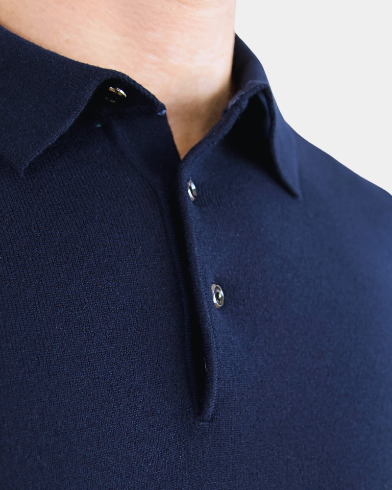 Close-up of By Alden luxury navy merino wool knit. Minimalist texture with a precise placket and polished button details. #color_navy