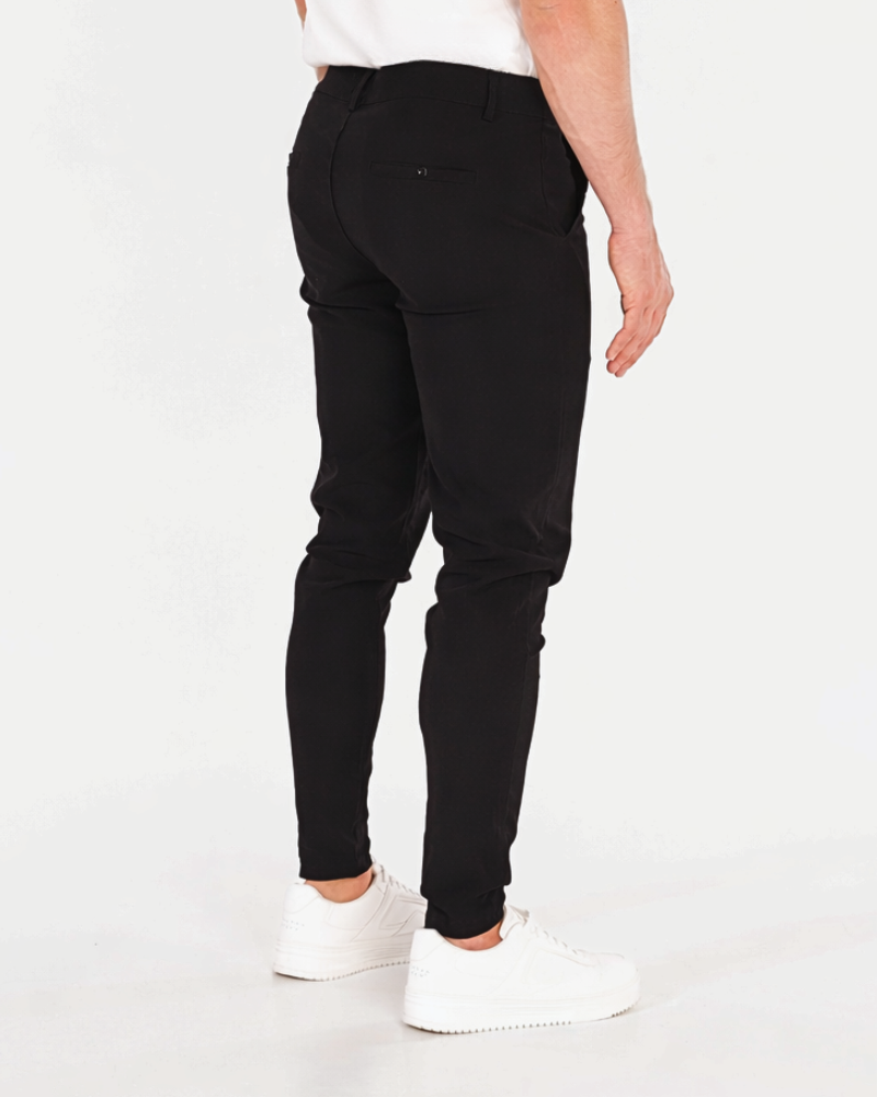 By Alden Luxury black stretch cotton chinos featuring a slim minimalist fit and subtle pocket detailing for a clean aesthetic. #color_black