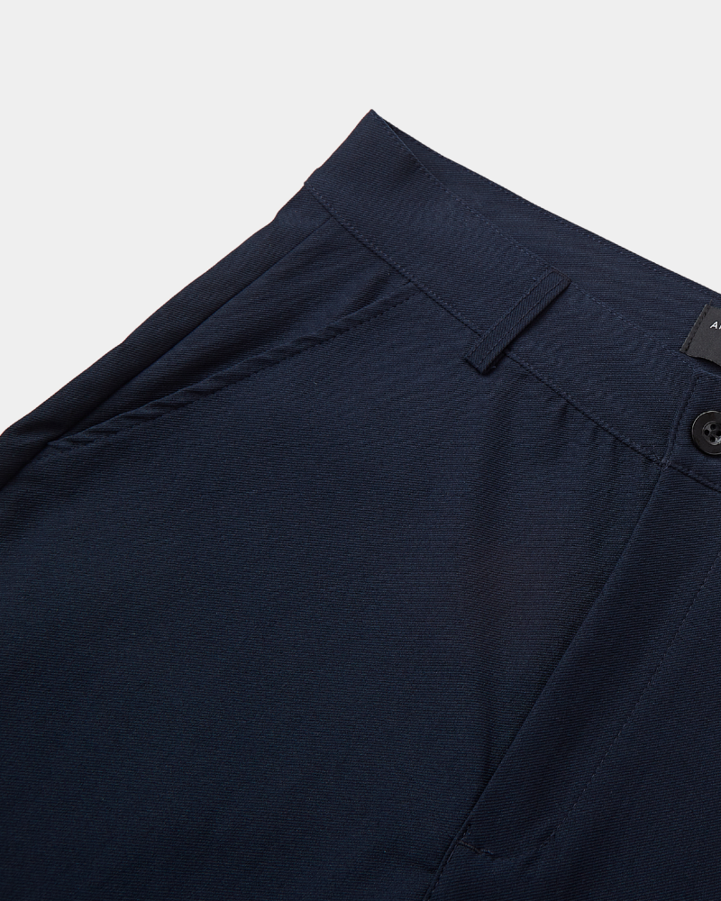 Close-up of By Alden minimalist luxury navy chinos in a breathable twill cotton-stretch fabric with a clean-tailored waistband. #color_navy