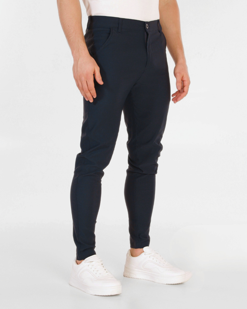 By Alden Minimalist navy luxury chinos in a slim-fit stretch cotton blend, styled with white sneakers for a refined aesthetic. #color_navy @model-info
