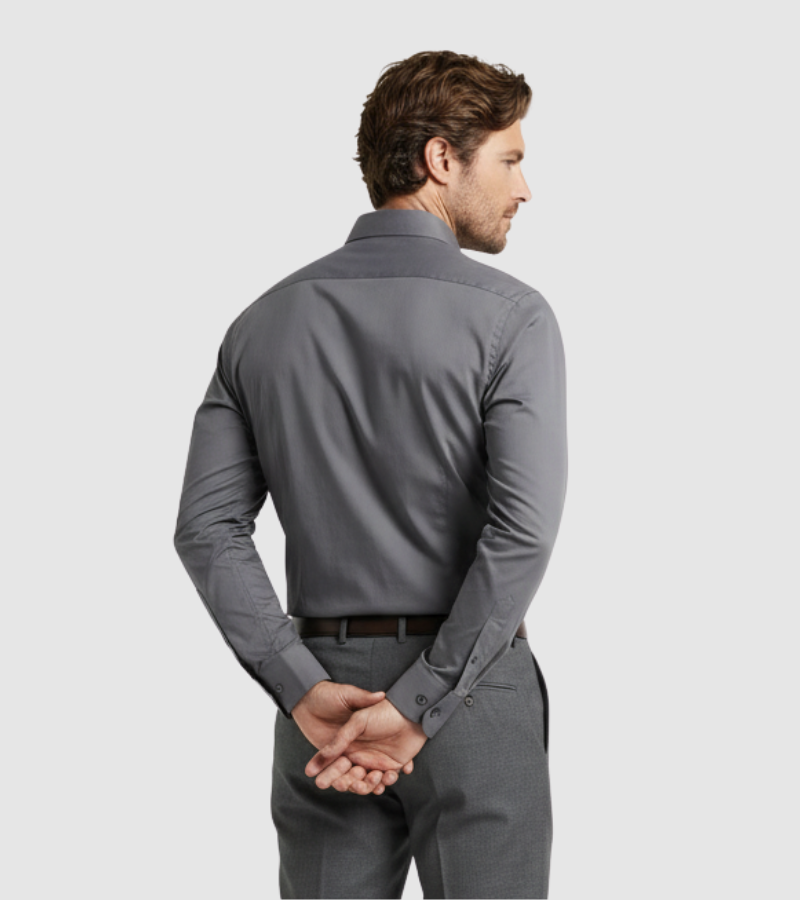 Man wearing a gray dress shirt and pants on a light gray background