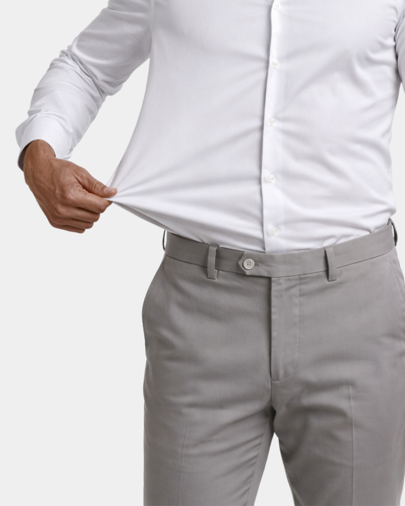 Minimalist luxury white shirt detail. Close-up of hand stretching performance cotton-spandex fabric to show flexibility.