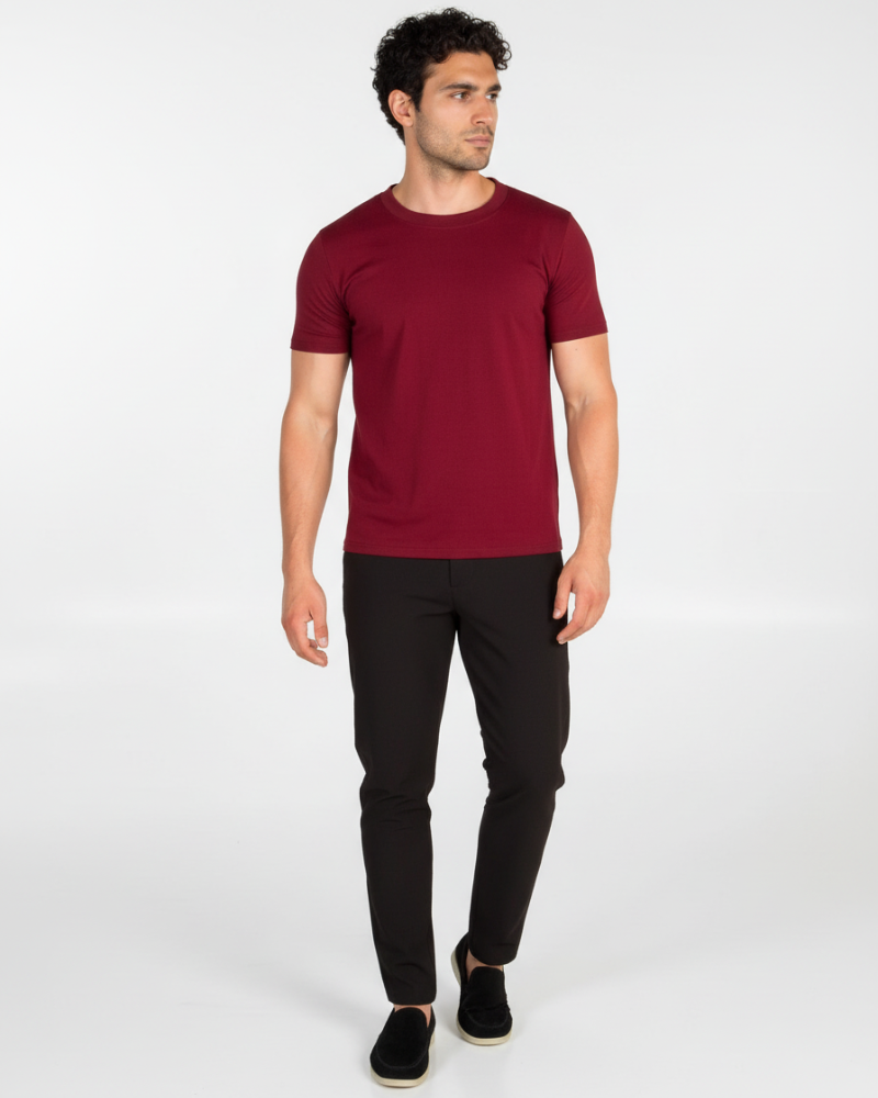 Model in a luxury burgundy Smart Fit T-shirt, styled for a minimalist professional look in motion.