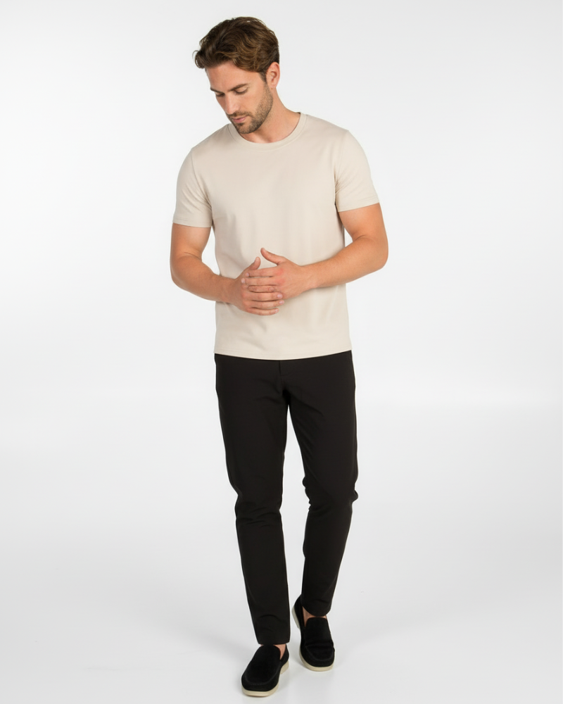 Model in a luxury sand Smart Fit T-shirt, styled for a minimalist professional look in motion.