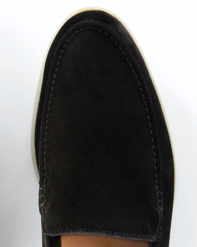 Close-up of By Alden luxury black suede loafers showing fine texture, minimalist stitching, and a premium almond-toe fit. #color_black