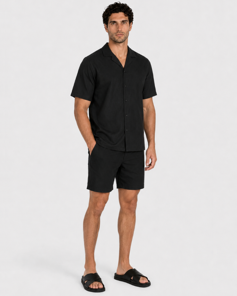 By Alden Black Linen Shorts worn by a male model, cropped front angle view, white background #Color_black