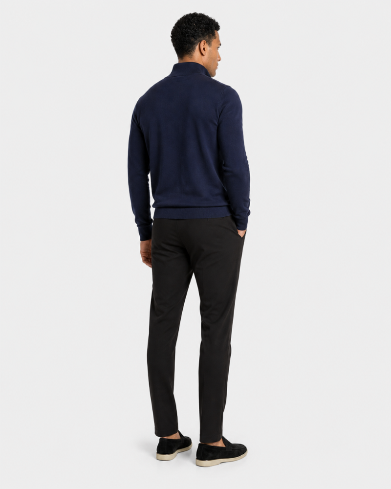 Man wearing a By Alden navy sweater and black pants on a white background #color_navy