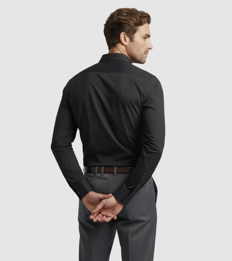 Man wearing a black long-sleeve shirt and gray pants on a light gray background