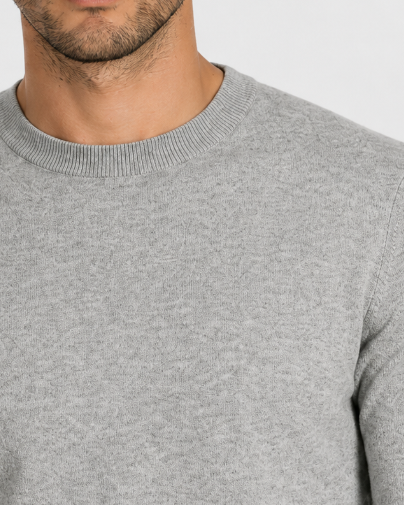 By Alden Light Grey Crew Neck Knit Sweater worn by a male model, close-up front view of neckline and fabric detail, light grey background #Color_Gray