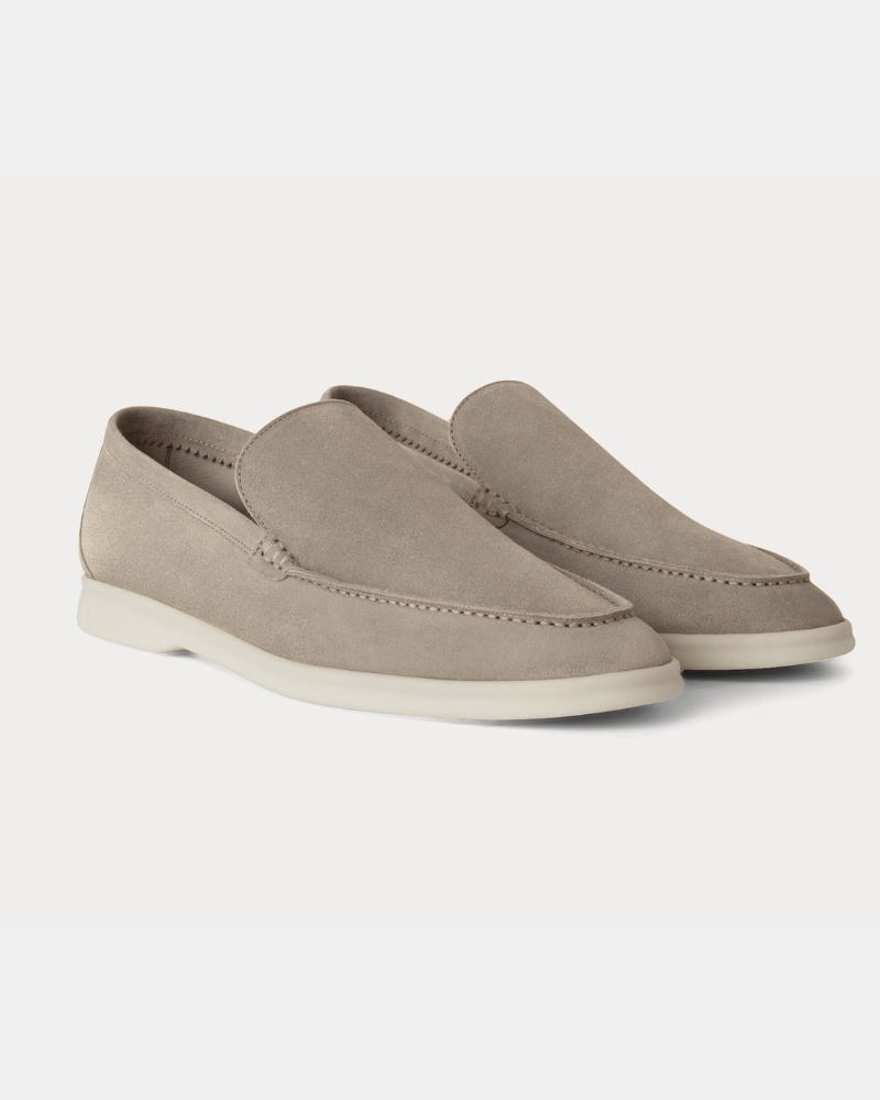 By Alden Luxury stone suede yacht loafers with minimalist off-white soles, highlighting an elegant slip-on fit and premium texture. #color_stone