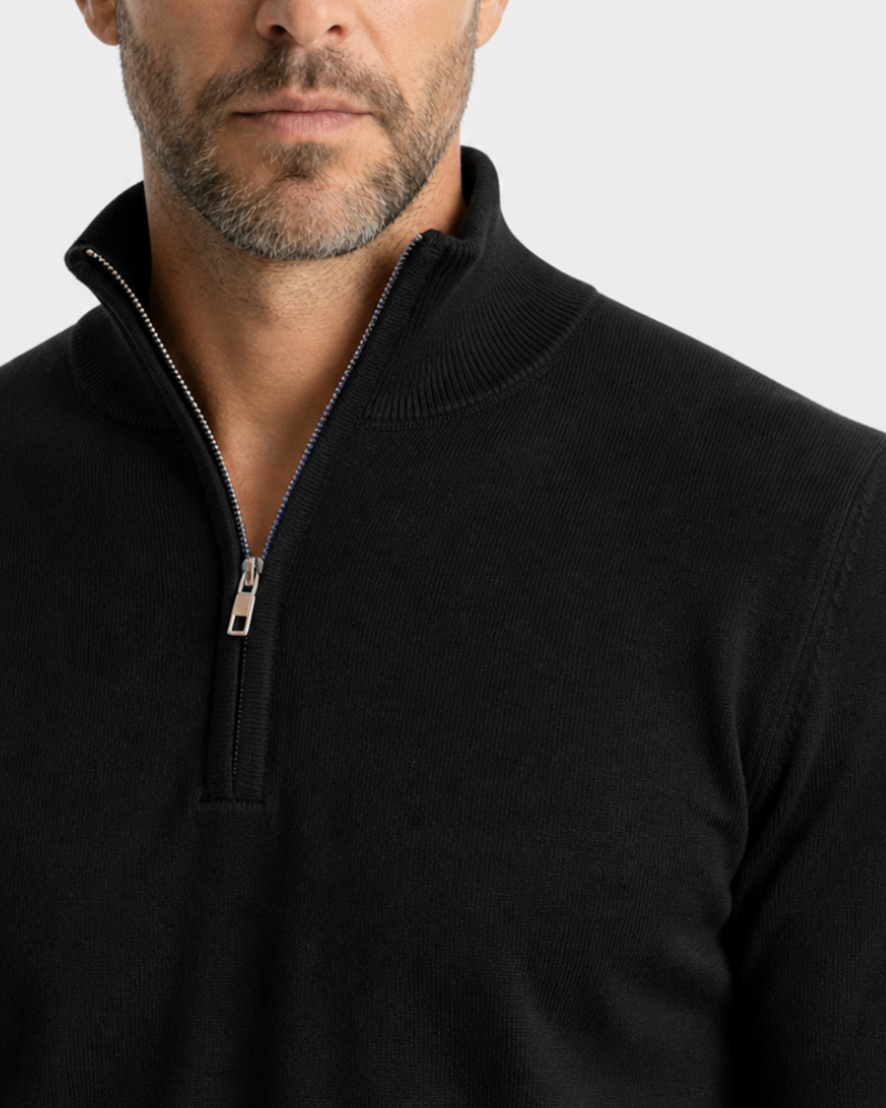 Man wearing a By Alden black quarter-zip sweater against a light gray background #color_black
