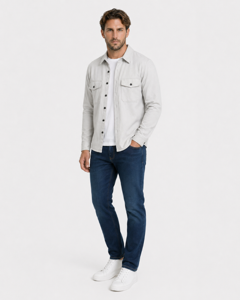 Man wearing a light By Alden gray shirt, white shirt, blue jeans, and white sneakers on a white background #color_gray