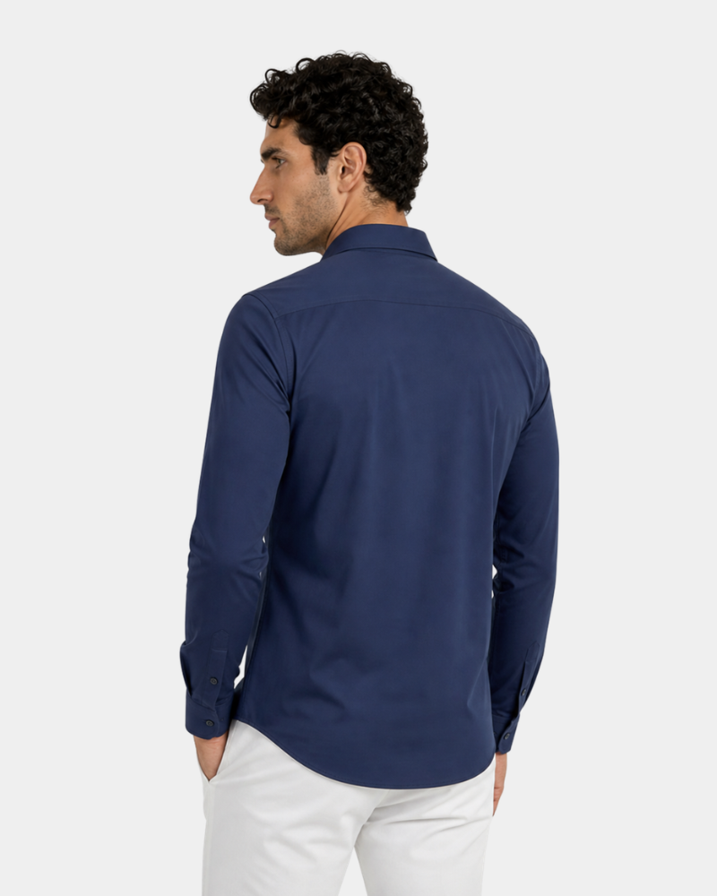 By Alden Navy Slim Fit Dress Shirt worn by a male model, cropped back angle view, light grey background #color_navy