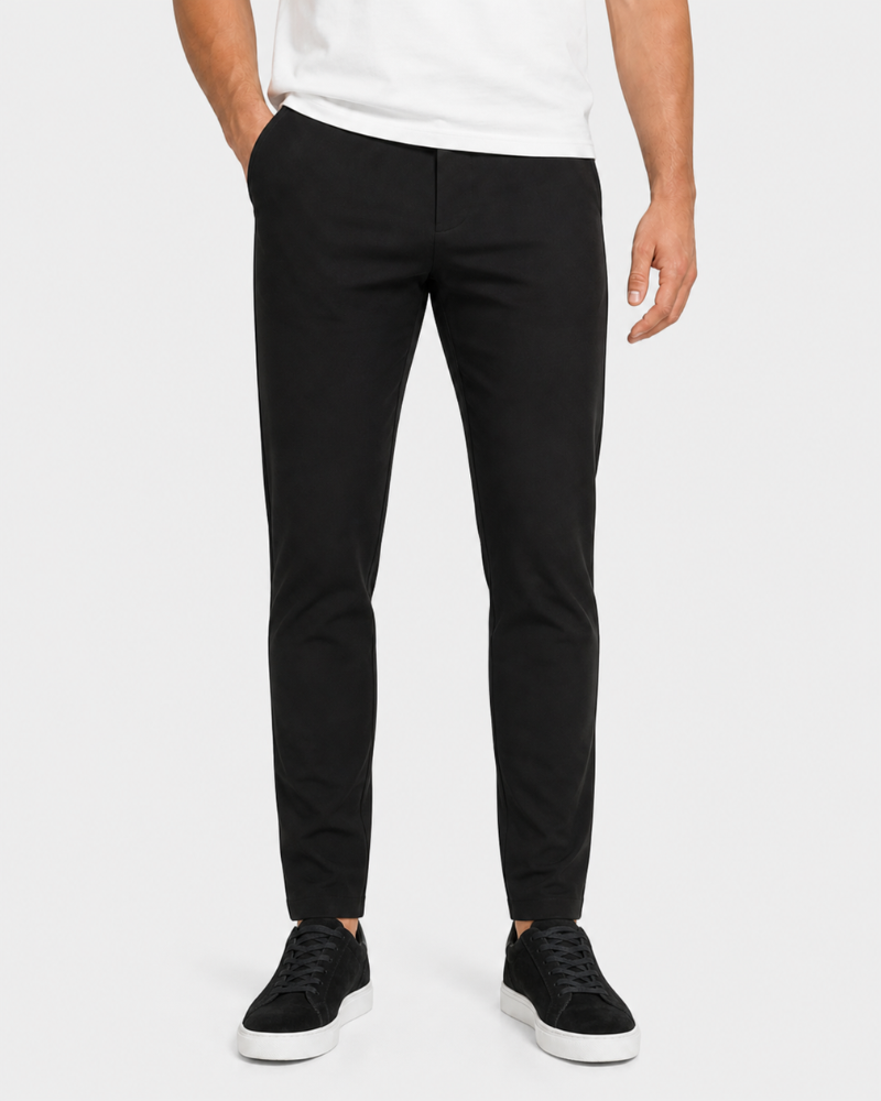 Person wearing By Alden black pants and a white shirt on a white background #Color_black