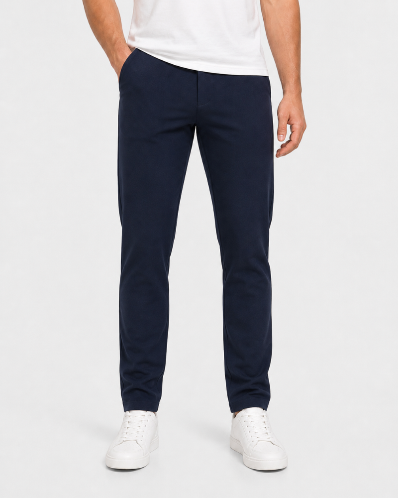 Person wearing By Alden navy pants and white shoes on a white background #Color_navy