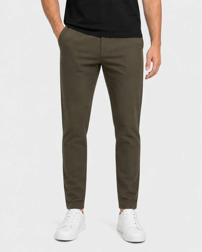 Person wearing By Alden olive green pants and white sneakers on a white background #Color_olive green