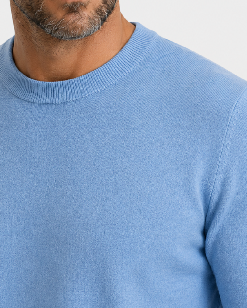 By Alden Sky Blue Crew Neck Knit Sweater worn by a white male model, close-up front view of neckline and fabric detail, light grey background #Color_light blue