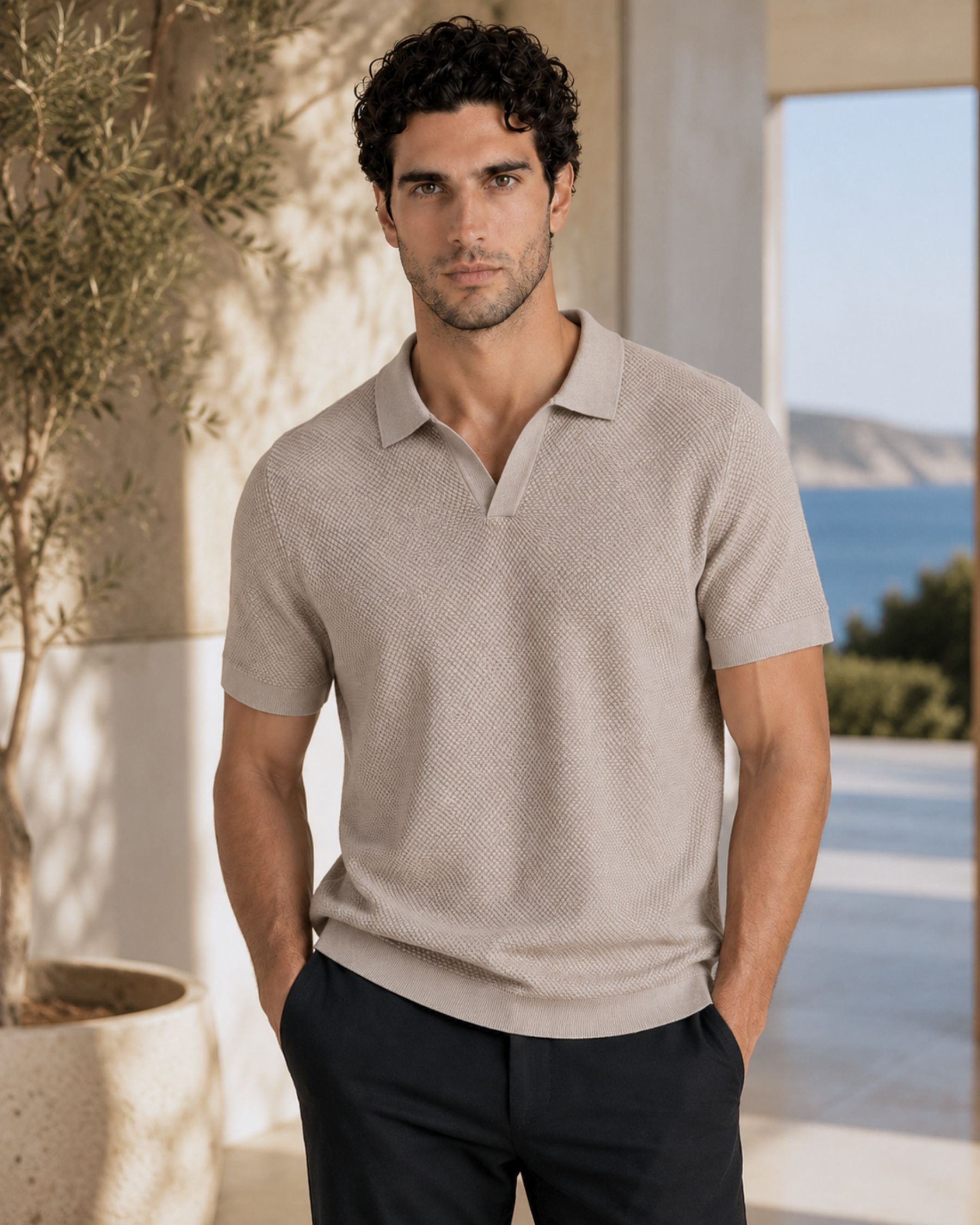 By Alden Stone open-collar knit polo shirt on male model, front view, upper body, outdoor blue sea background. #color_stone