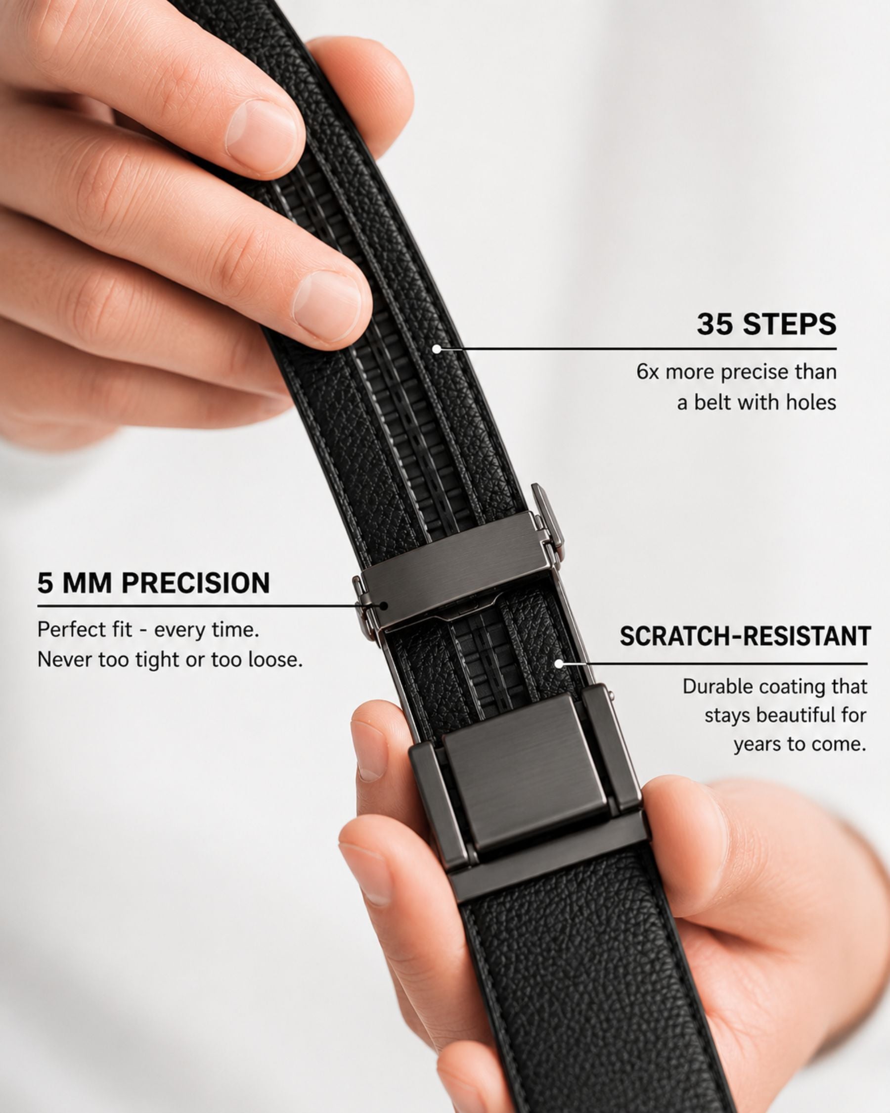 By Alden black leather ratchet belt buckle mechanism detail, male model holding belt, close-up, white background. #color_black