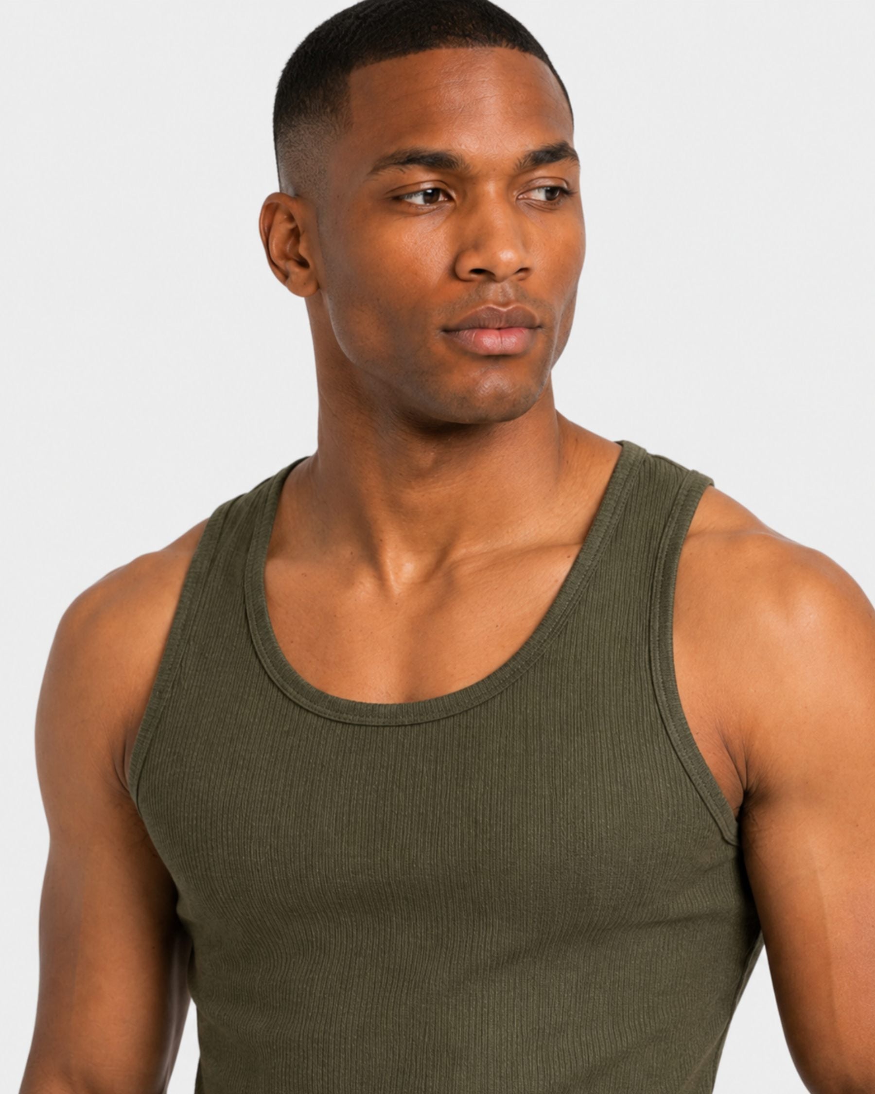 By Alden green ribbed tank top on male model, close-up detail of neckline and shoulder, light gray background #Color_green