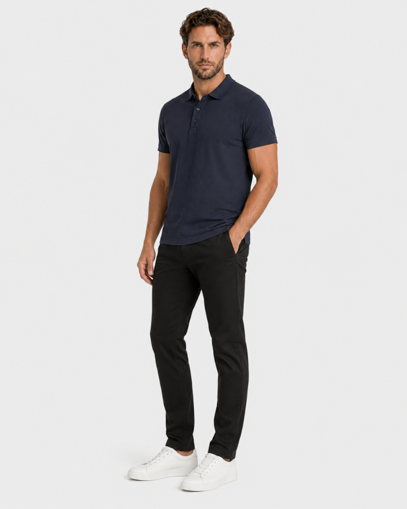 By Alden navy blue knit polo shirt on male model, three-quarter view, full body, light gray background. #color_navy