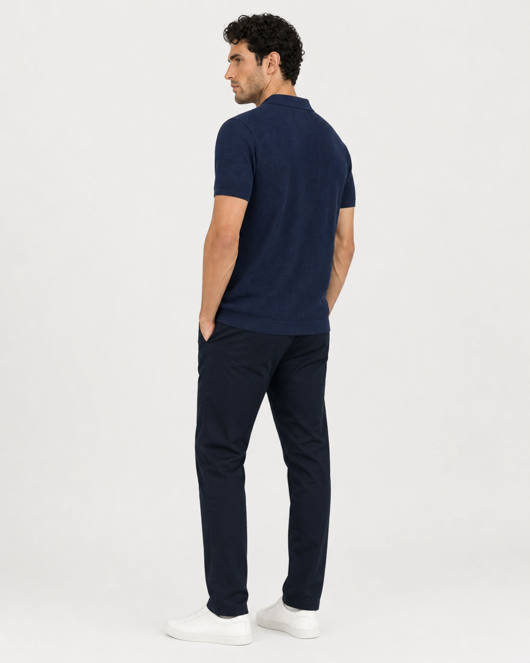 By Alden navy open-collar knit polo shirt on male model, back view, full body, light gray background. #Color_navy