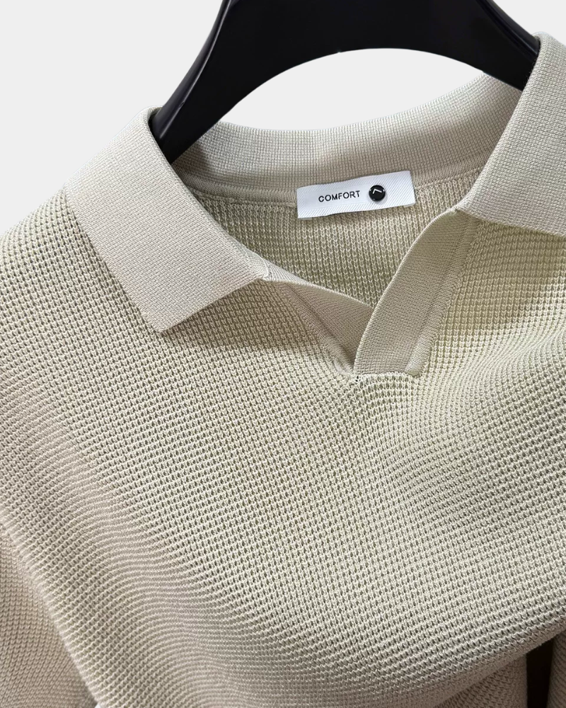 By Alden off white open-collar knit polo shirt collar and label detail, hanger, close-up, light gray background.
#color_off white
