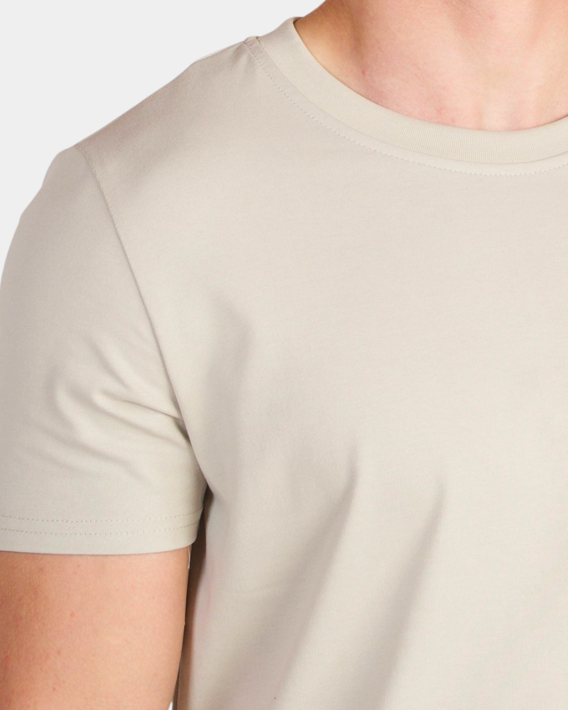 By Alden stone crew neck t-shirt on male Caucasian model, close-up shoulder detail, gray bg #color_stone