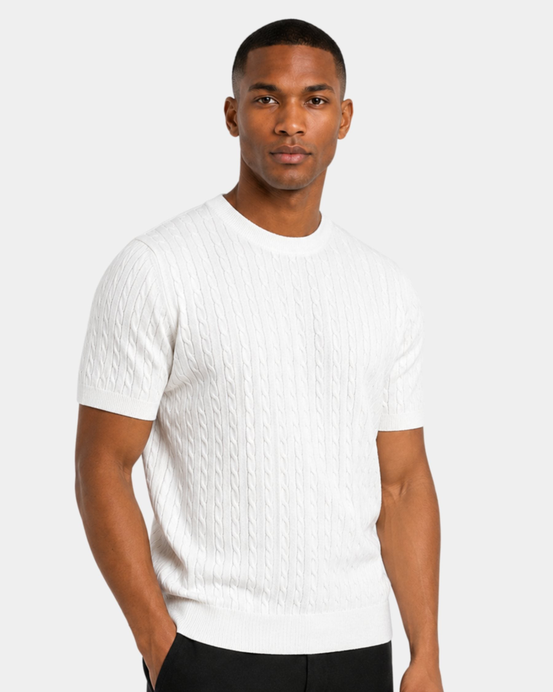 By Alden white cable-knit short-sleeve sweater on male model, three-quarter view upper body, light gray background #color_white