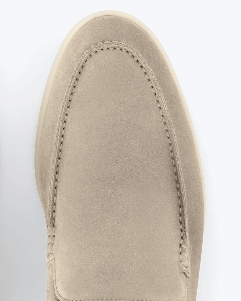 Close-up of By Alden luxury stone suede loafers showing fine texture, tonal minimalist stitching, and a premium almond-toe fit. #color_stone