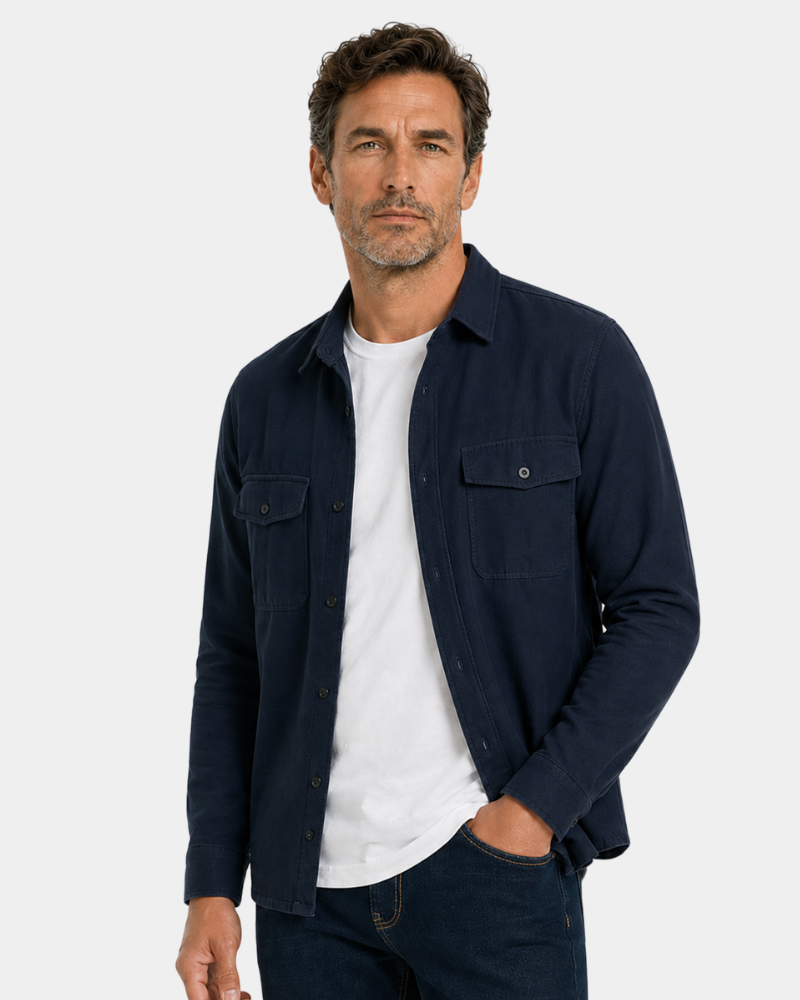 Man wearing a By Alden navy shirt over a white t-shirt on a light gray background #color_navy